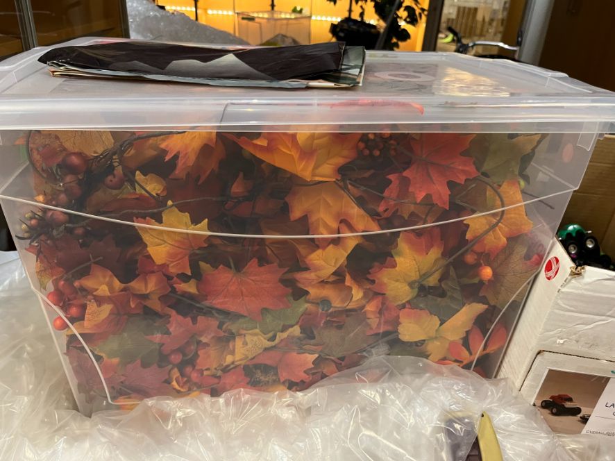 Bin of artifical fall-coloured leaves