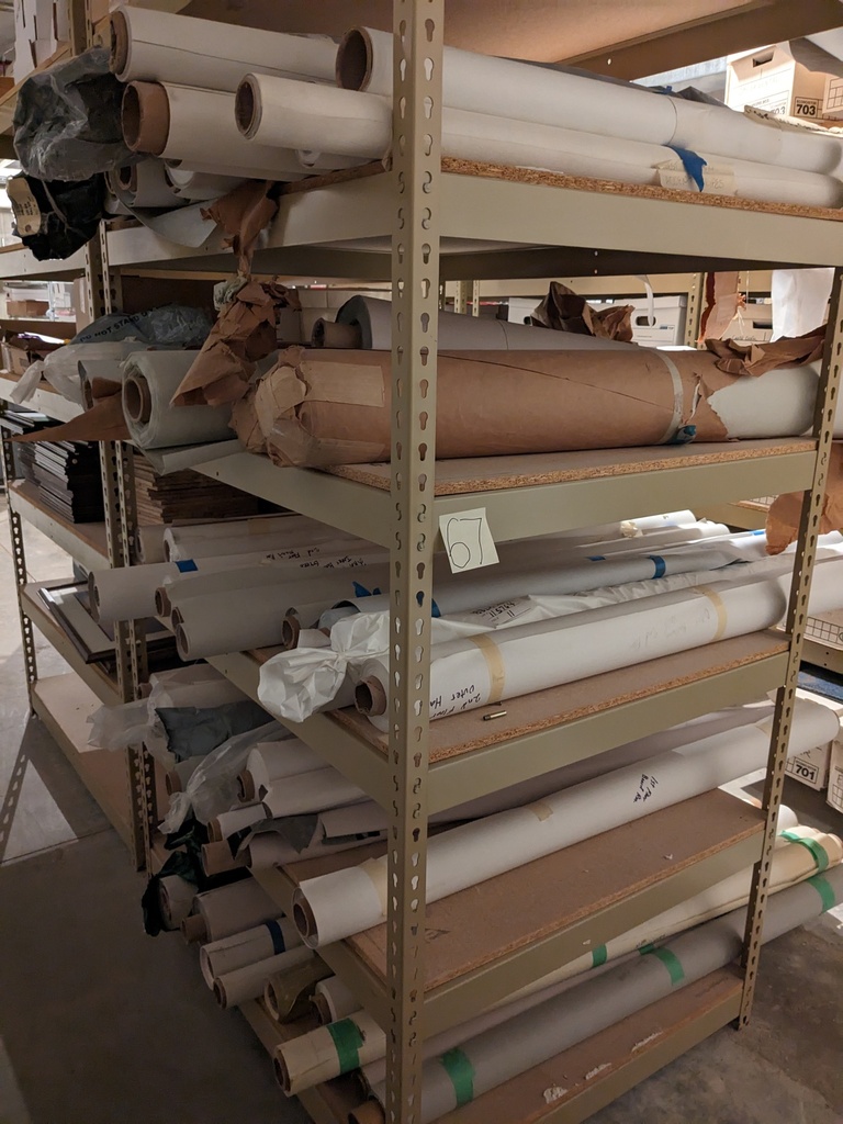 contents of large wire/partical board racks in back corner (wallcovering)