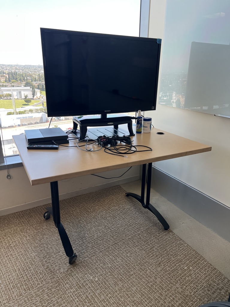 Small Desk - tan top, black base, missing 2 wheels (right side)