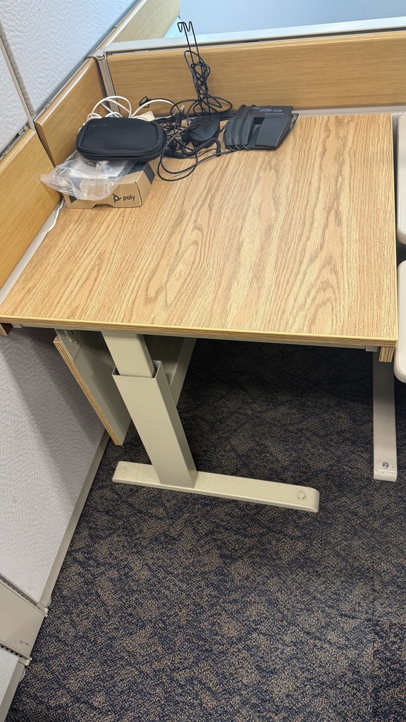 Large office desk with yellow wooden top and metal legs, adjustable