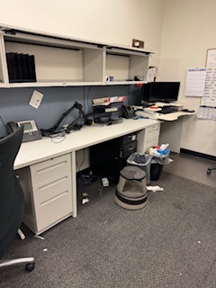Straight grey desk with overheads