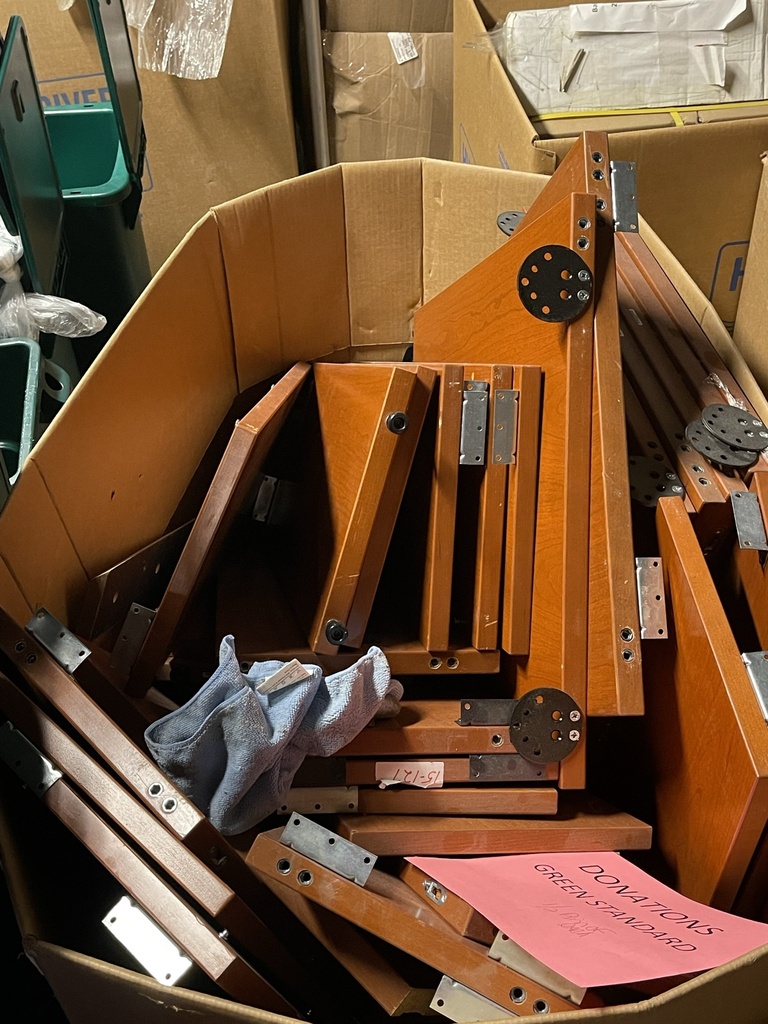 Large bin of wood supports for desks