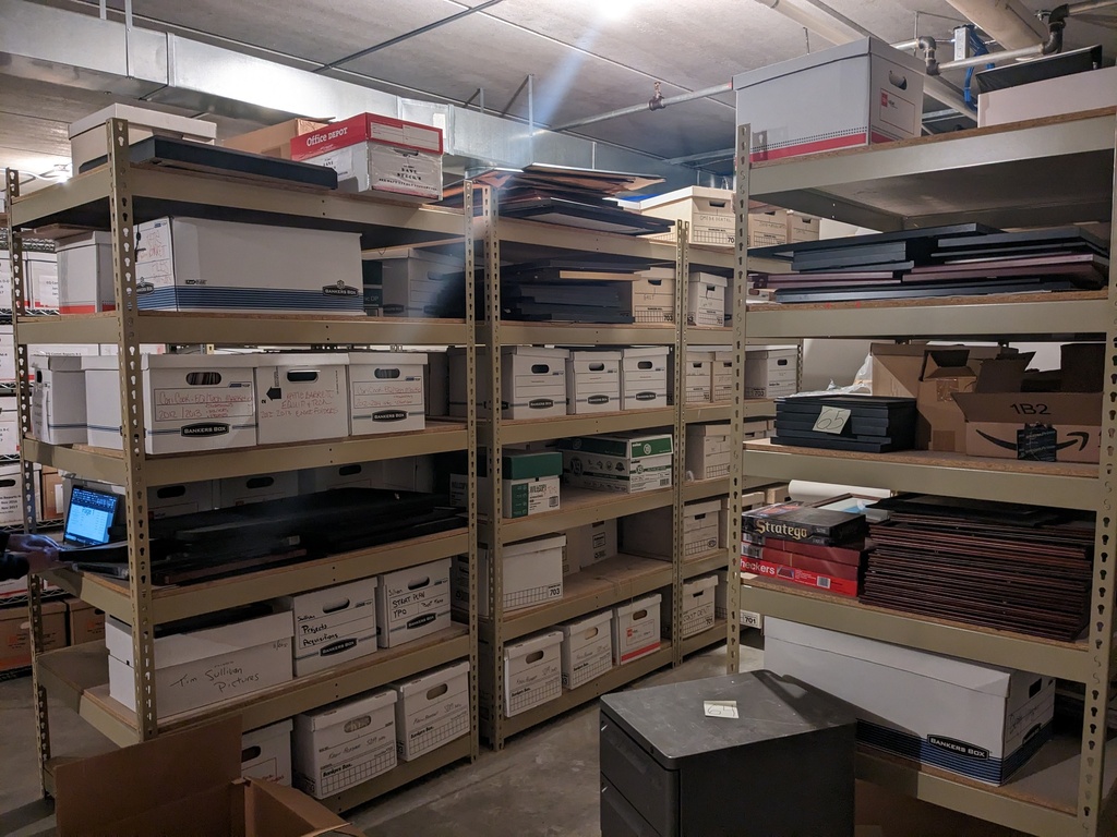 contents of large wire/partical board racks in back corner (picture frames***