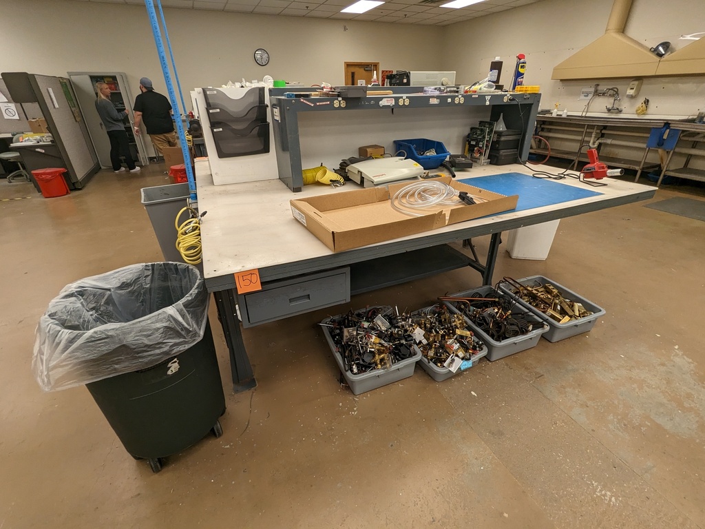 work bench with larger pedestal, bolted to floor, metal base and acrylic top w/ electric shelf overhead