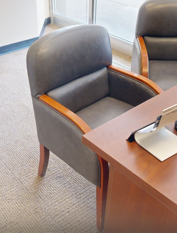 Grey padded guest chair with arms