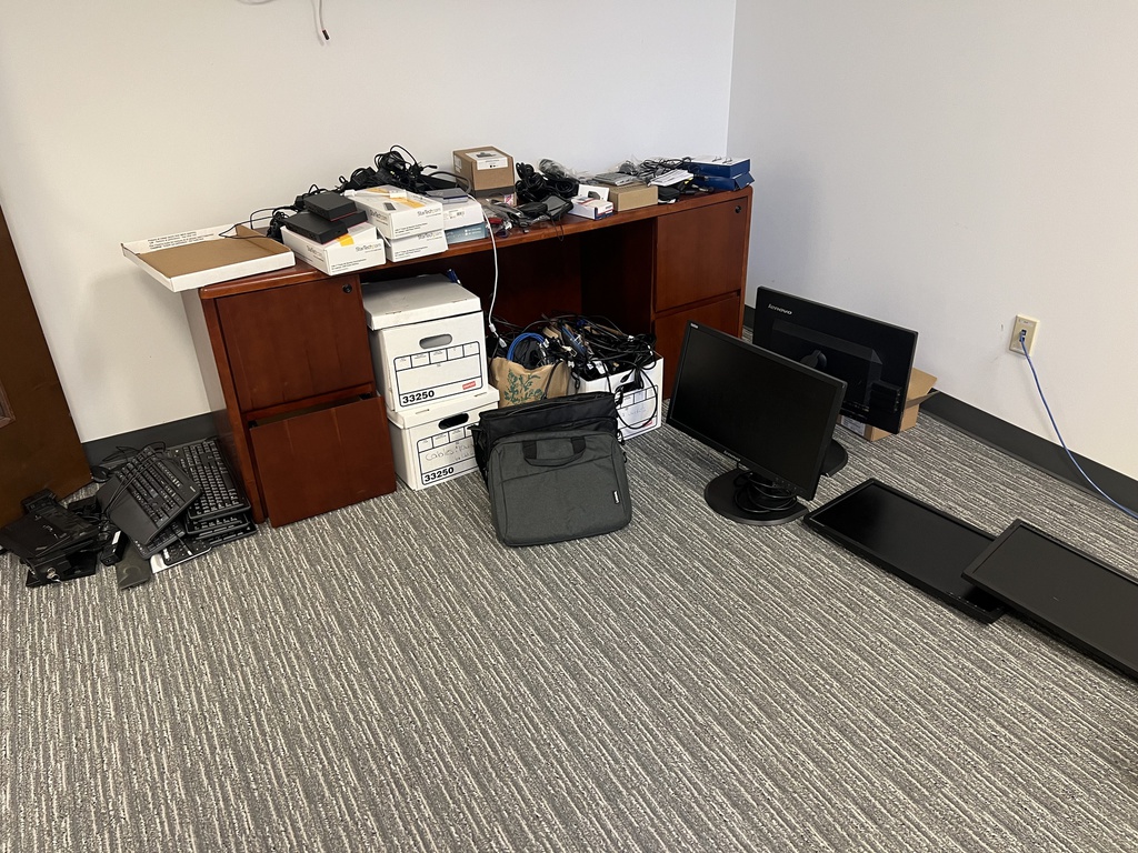 Misc. piles of keyboard trays, mouses, etc. 