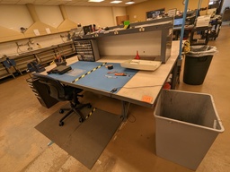 [#A3-145] work bench with smaller pedestal, bolted to floor, metal base and acrylic top w/ electric shelf overhead